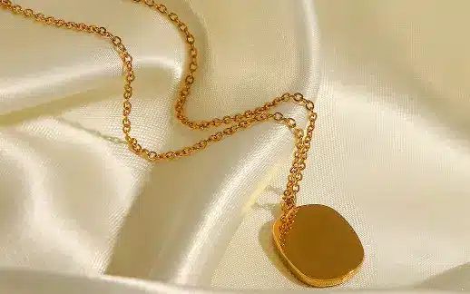 Vintage Chanel gold plated necklace with prominent logo.