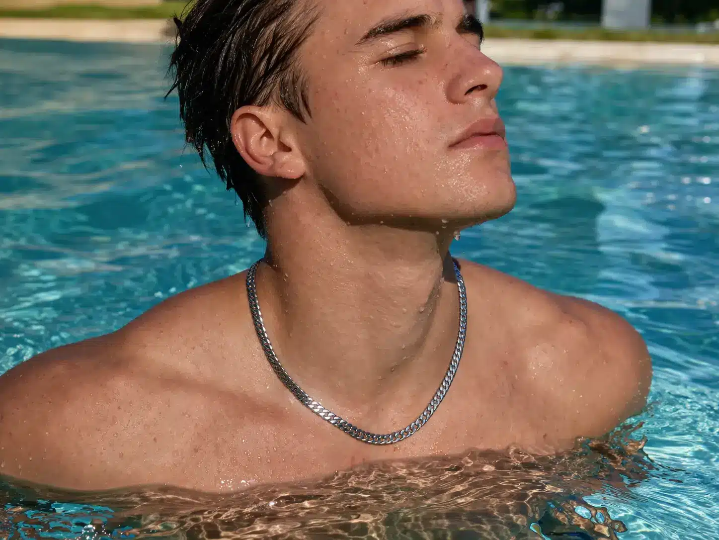 Model wearing waterproof jewelry in water